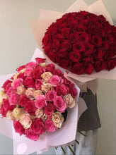 Woman holding Petal Kiss bouquet 50 roses presentation