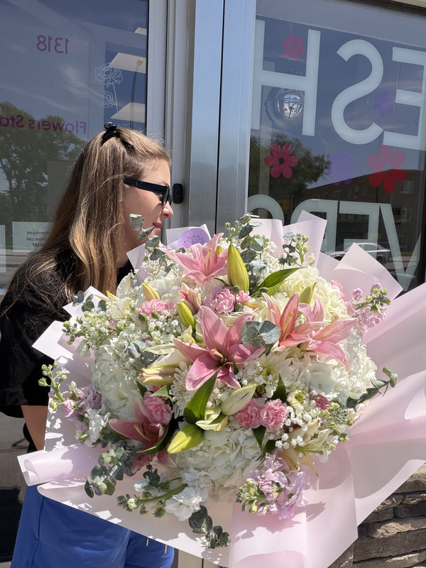 Grand luxury bouquet with pink lilies, white hydrangeas, pink carnations and eucalyptus in premium pink wrap — Flowers Station Winnipeg