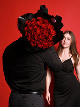 From a Gentleman bouquet 25 red roses wrapped in black paper - Flowers Station Winnipeg