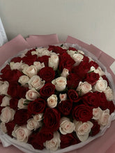 100 pink and red roses arranged in round box presentation