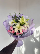 Woman holding Lavender Morning bouquet soft pastel flowers