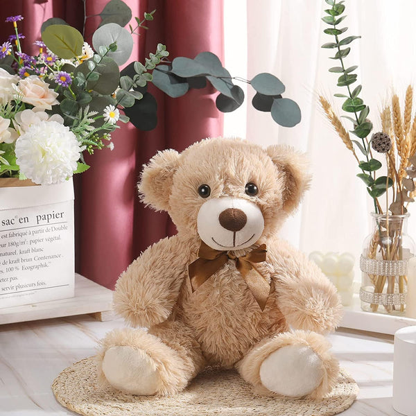 Cuddly 14-inch plush teddy bear with ribbon next to gift box and flowers — Flowers Station Winnipeg