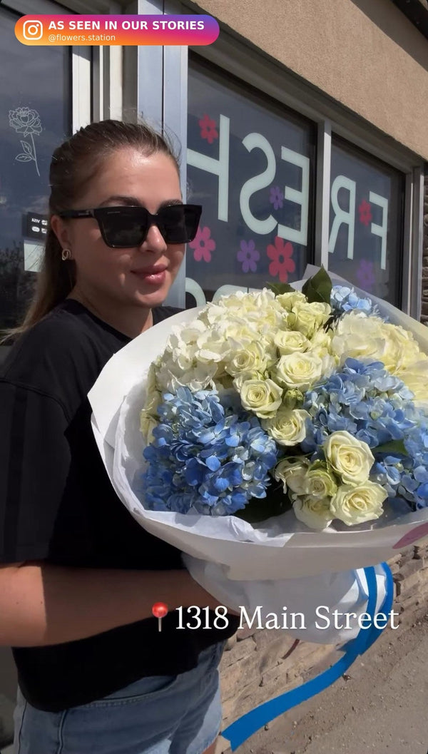 Large bouquet of blue and white hydrangeas with white roses and spray roses in white wrap — Flowers Station Winnipeg
